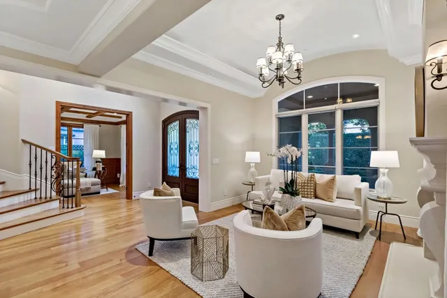 a living room with furniture a chandelier and a chandelier