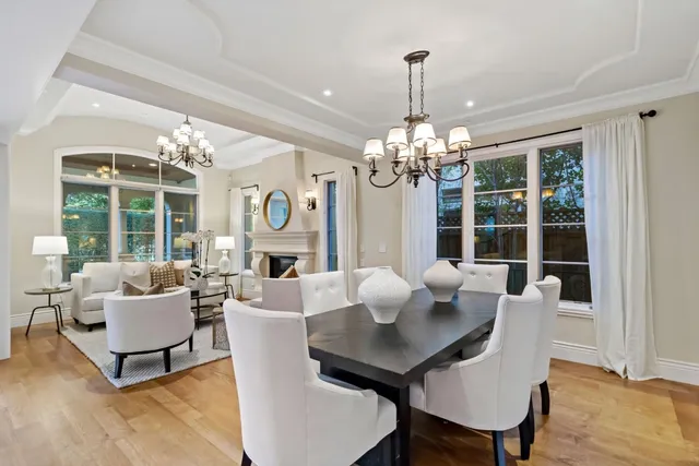 a view of a dining room with furniture wooden floor and chandelier
