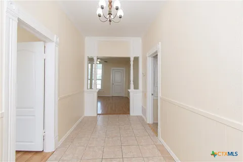 a view of a hallway with a chandelier