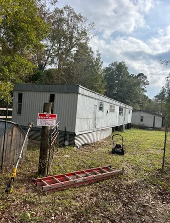 a backyard of a house with barbeque oven table and chairs