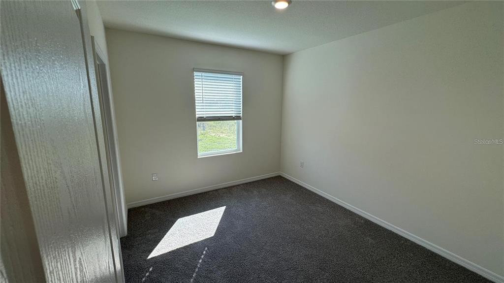 1442 Isleta Loop Kissimmee, FL 34741 - Photo 20 of 28 an empty room with windows