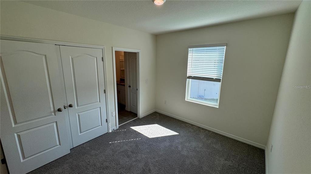1442 Isleta Loop Kissimmee, FL 34741 - Photo 21 of 28 a view of an empty room with a window