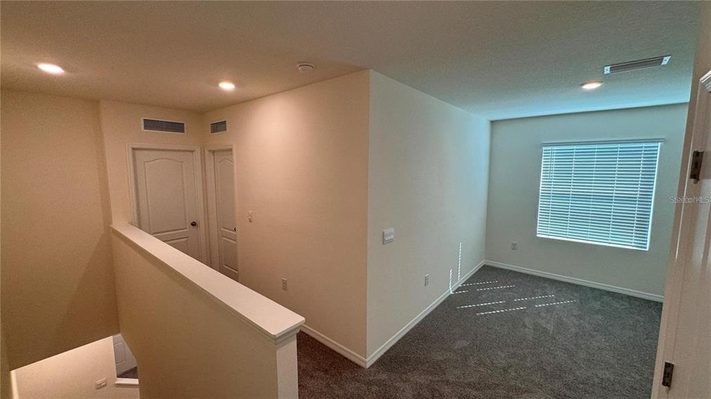 1442 Isleta Loop Kissimmee, FL 34741 - Photo 24 of 28 a view of an empty room with a window