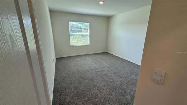 an empty room with closet area