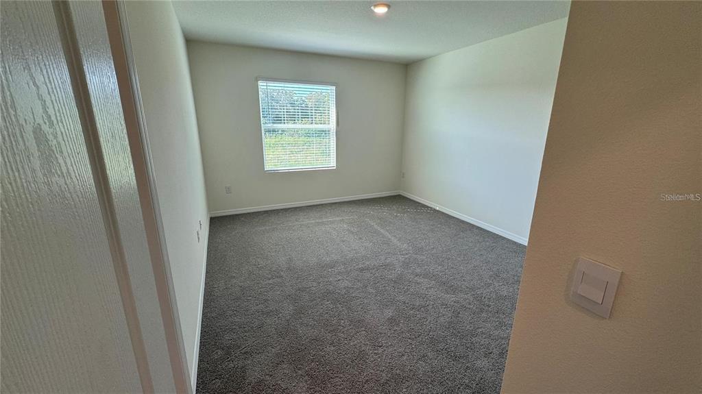 1442 Isleta Loop Kissimmee, FL 34741 - Photo 25 of 28 a view of an empty room with a window
