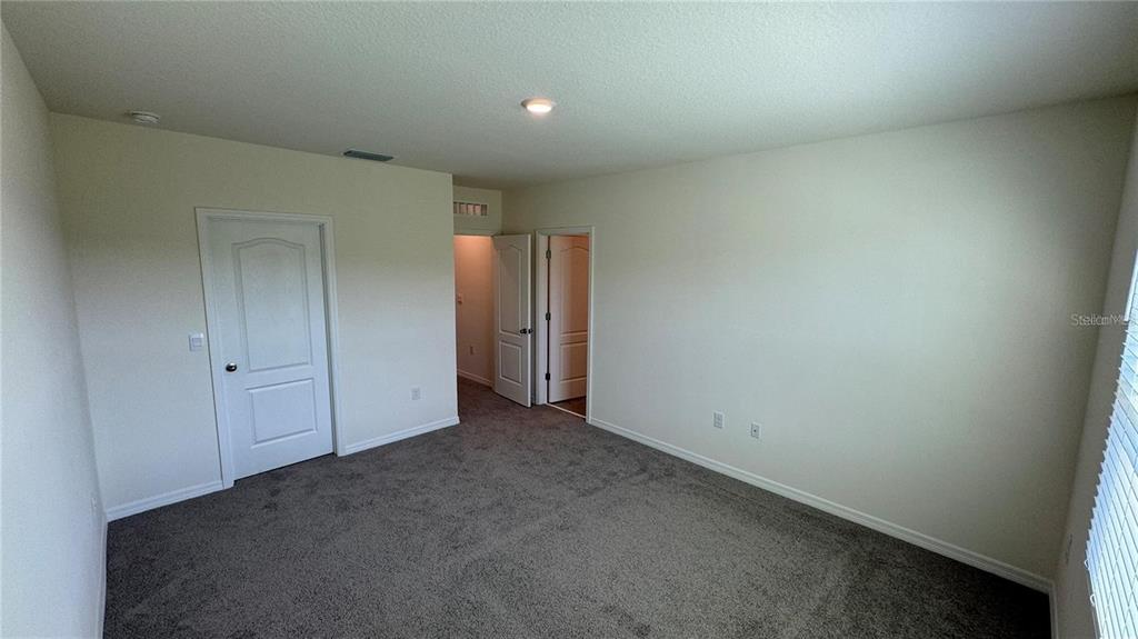 1442 Isleta Loop Kissimmee, FL 34741 - Photo 26 of 28 an empty room with closet area