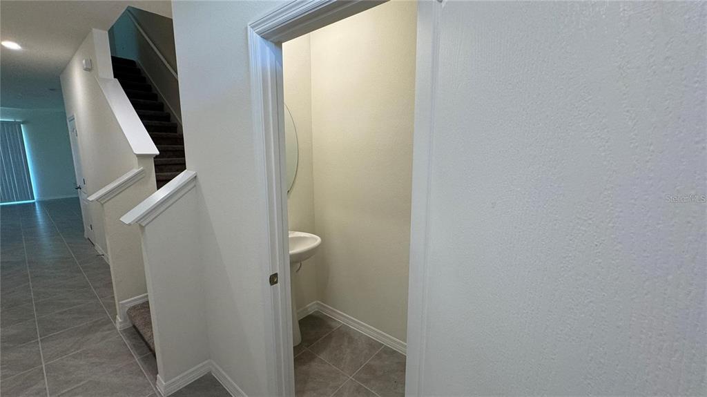 1442 Isleta Loop Kissimmee, FL 34741 - Photo 9 of 28 a bathroom with a sink and mirror