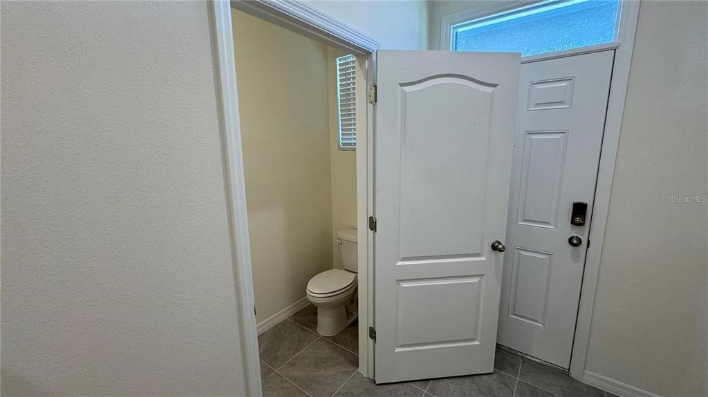 1442 Isleta Loop Kissimmee, FL 34741 - Photo 10 of 28 a bathroom with a granite countertop sink toilet and shower
