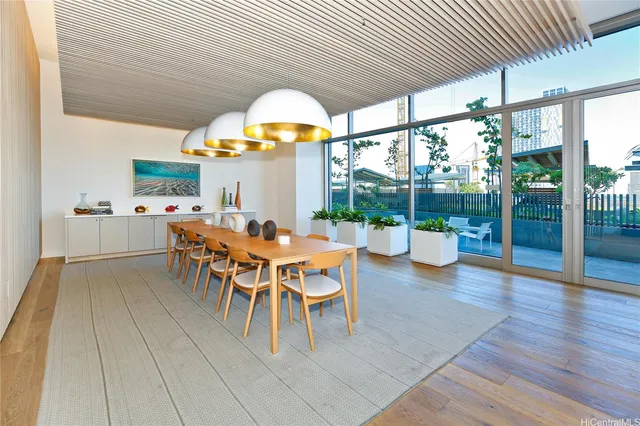 a view of a dining room with furniture a chandelier and wooden floor
