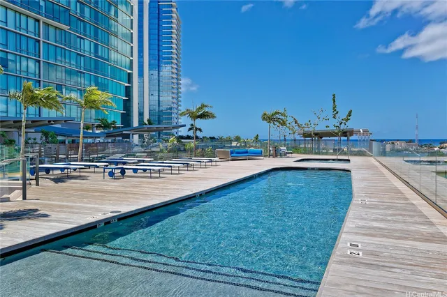 a swimming pool with outdoor seating and yard