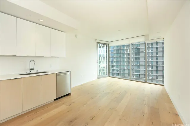 a kitchen with granite countertop a sink and a white stove