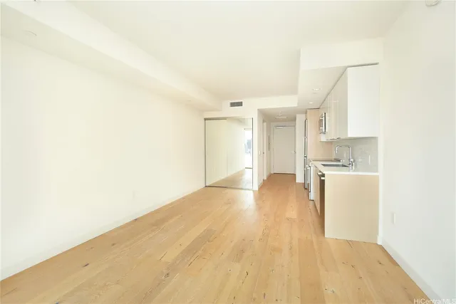 a view of a kitchen with a sink and a refrigerator