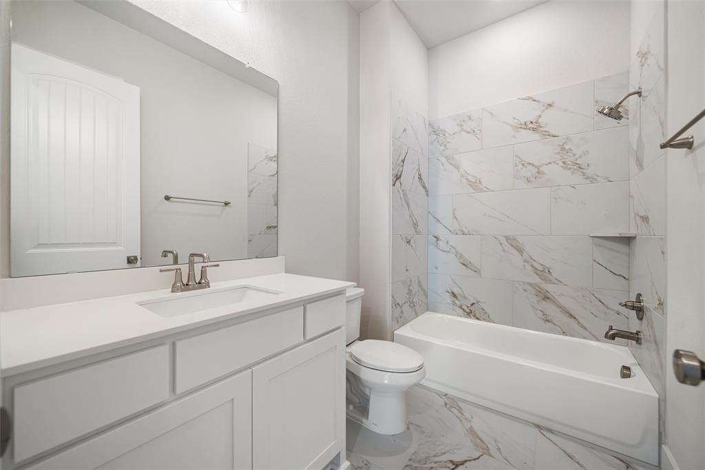 404 Indian Creek Road Van Alstyne, TX 75495 - Photo 11 of 40 a bathroom with a sink toilet and shower