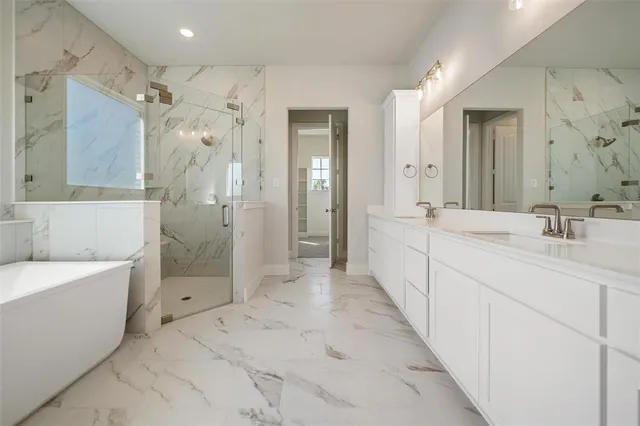 a spacious bathroom with a shower sink double and mirror