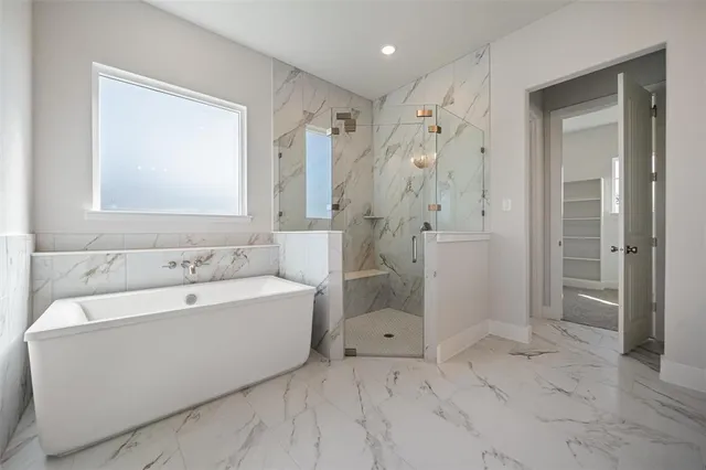 a spacious bathroom with a bathtub shower and toilet