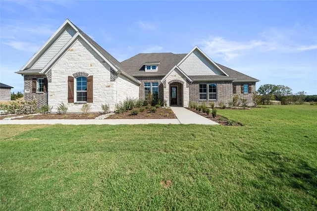a front view of house with yard and green space