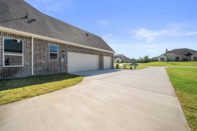 a view of a house with a yard and a garage