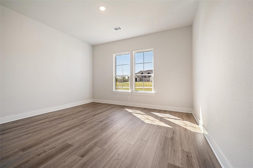 404 Indian Creek Road Van Alstyne, TX 75495 - Photo 10 of 40 an empty room with wooden floor and windows
