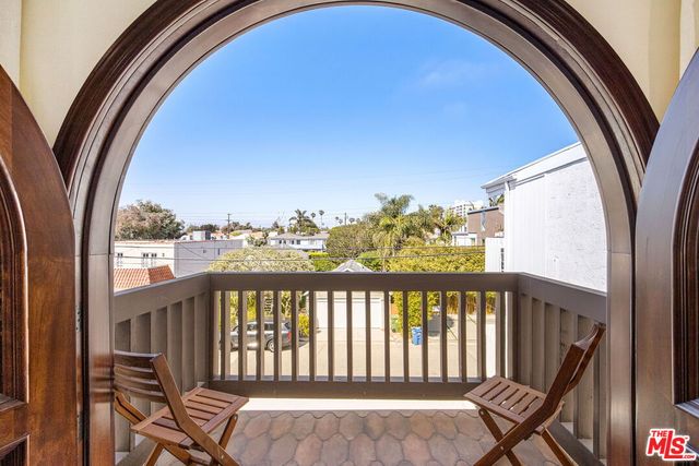 a view of a balcony with furniture and wooden floor