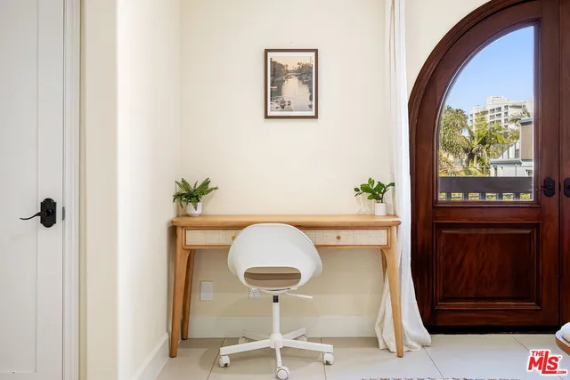 a view of a hallway with a potted plant and a dresser