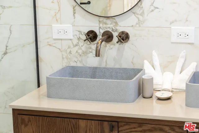 a white bath tub sitting next to a white wall