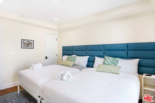 a bedroom with a bed and a night stand