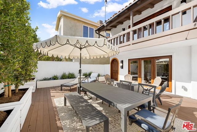 a view of a patio with table and chairs and potted plants