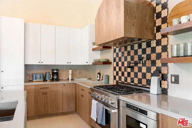 a kitchen with cabinets appliances and a sink