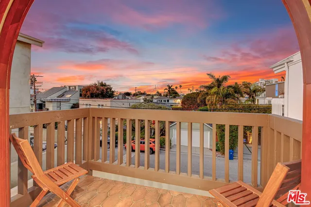 a balcony with wooden floor and city view