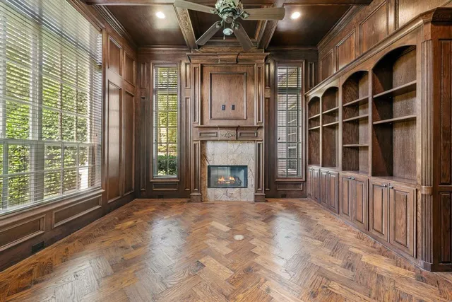 a view of an empty room with a fireplace and a window