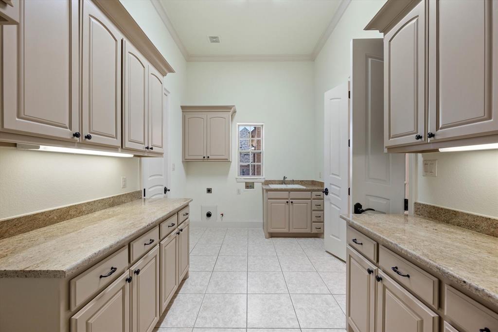 1600 Enclave Court Southlake, TX 76092 - Photo 31 of 40 a kitchen with a stove sink and cabinets