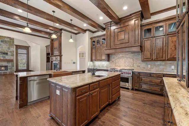 a kitchen with stainless steel appliances granite countertop a sink stove and cabinets