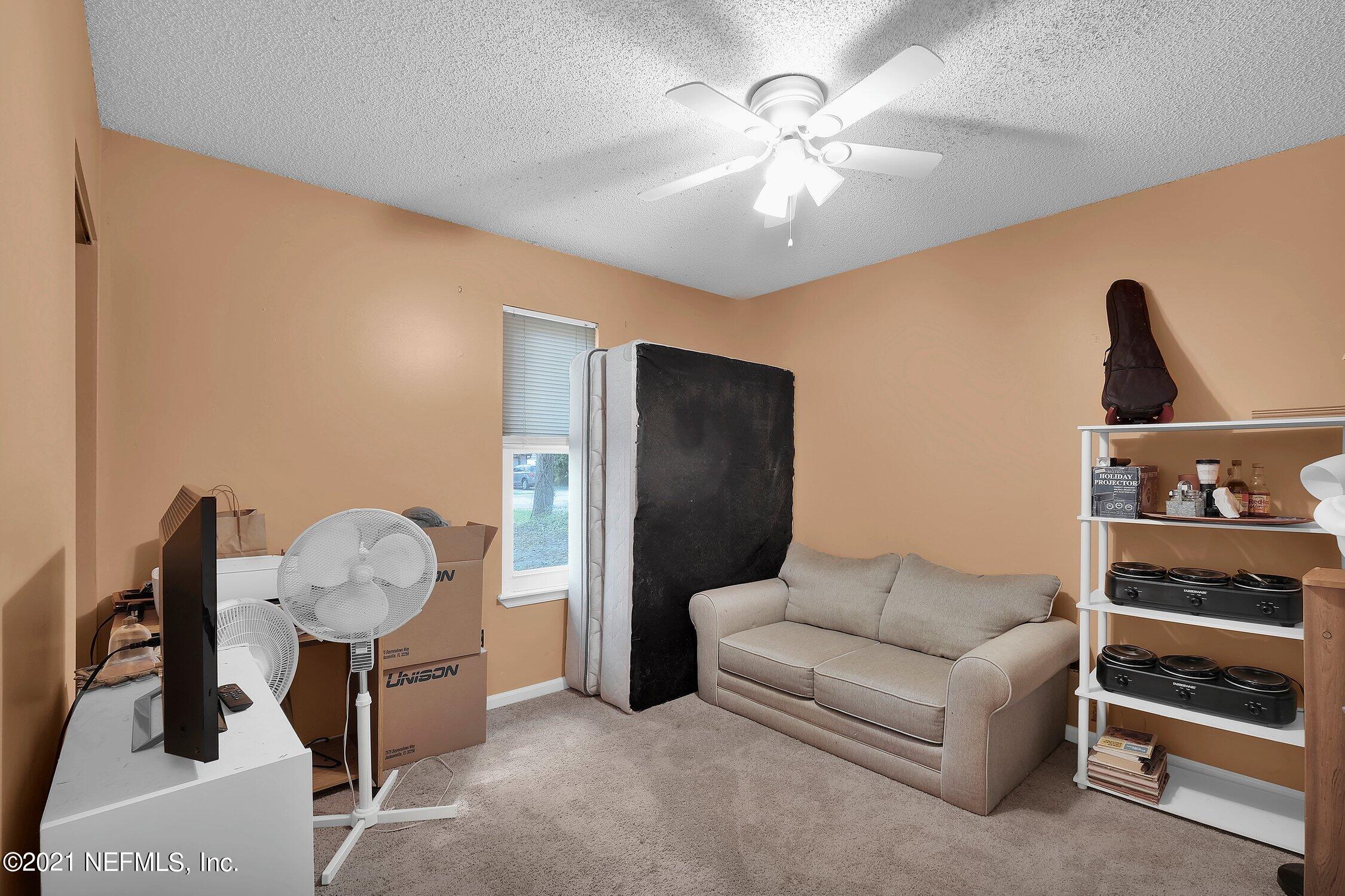 12840 Beaubien Road Jacksonville, FL 32258 - Photo 17 of 25 a living room with furniture and a chandelier