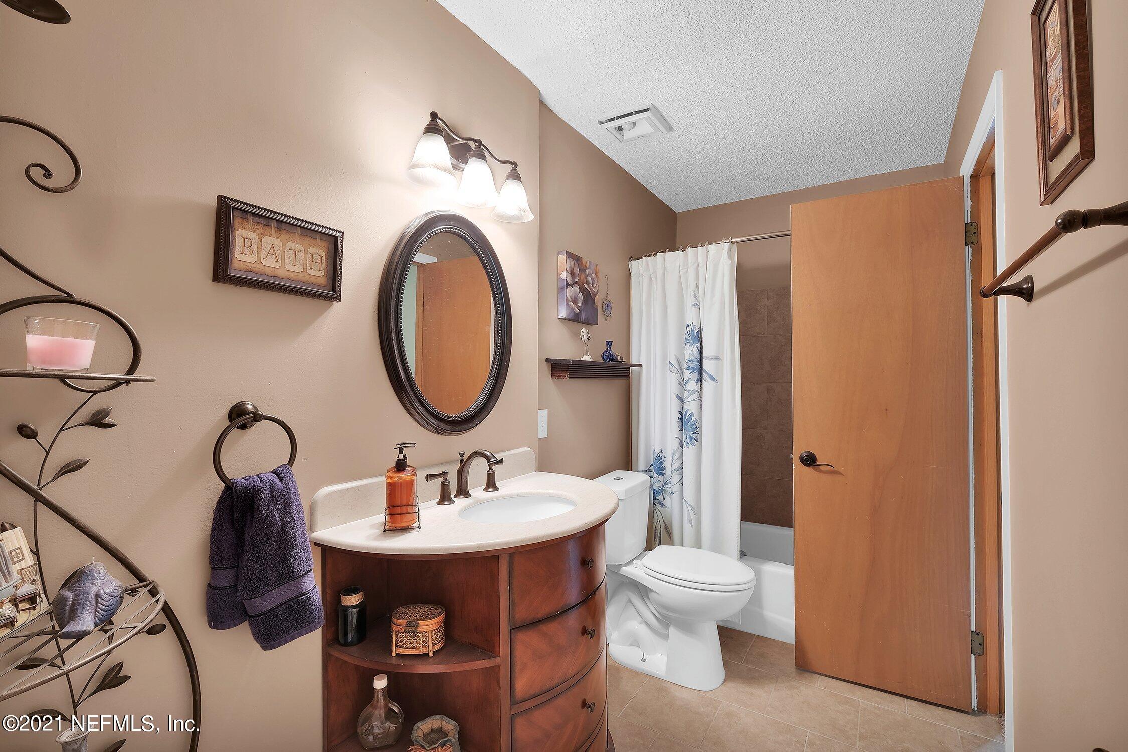 12840 Beaubien Road Jacksonville, FL 32258 - Photo 18 of 25 a bathroom with a toilet a sink and a mirror