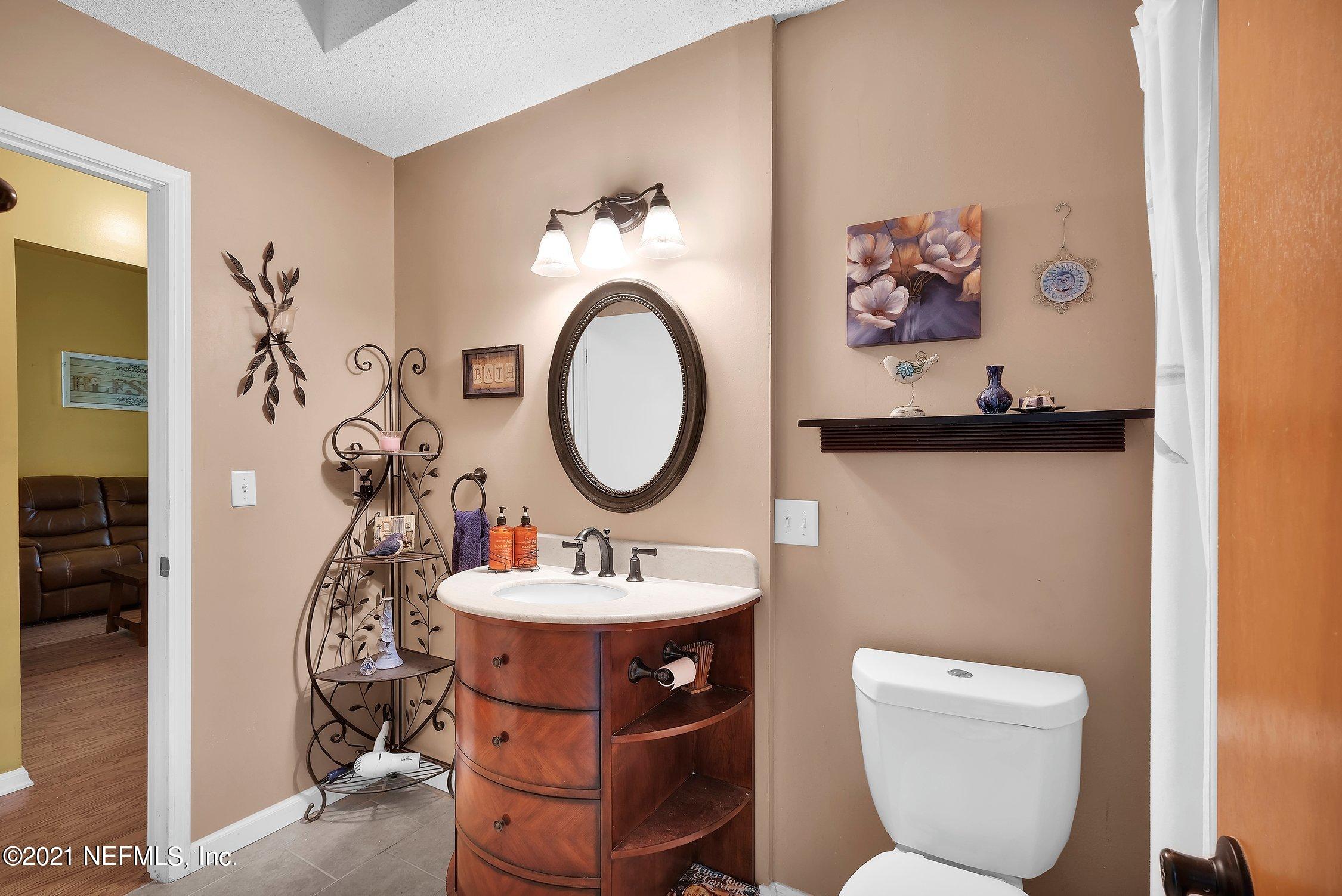 12840 Beaubien Road Jacksonville, FL 32258 - Photo 21 of 25 a bathroom with a toilet sink and mirror