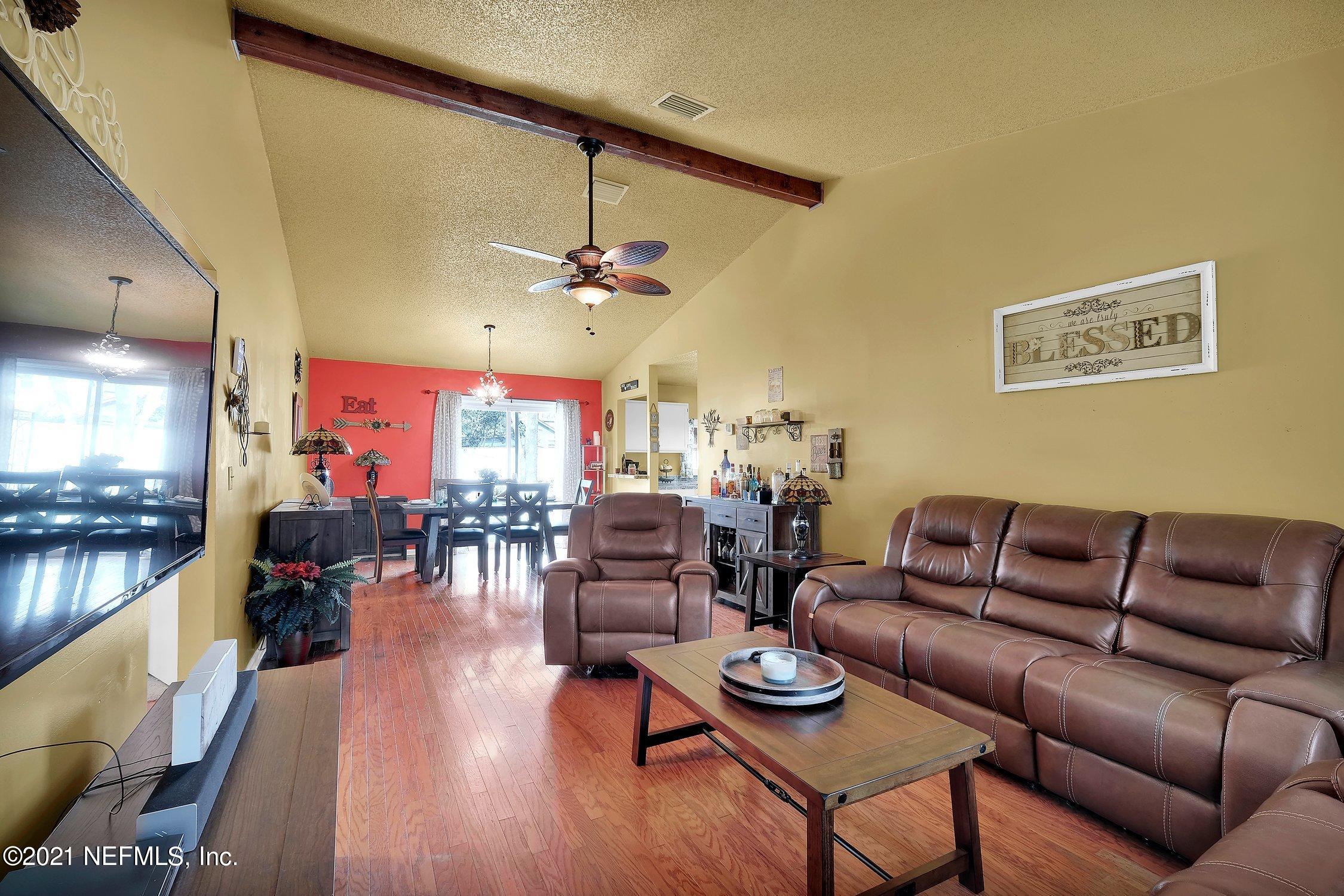 12840 Beaubien Road Jacksonville, FL 32258 - Photo 5 of 25 a living room with furniture kitchen view and a large window
