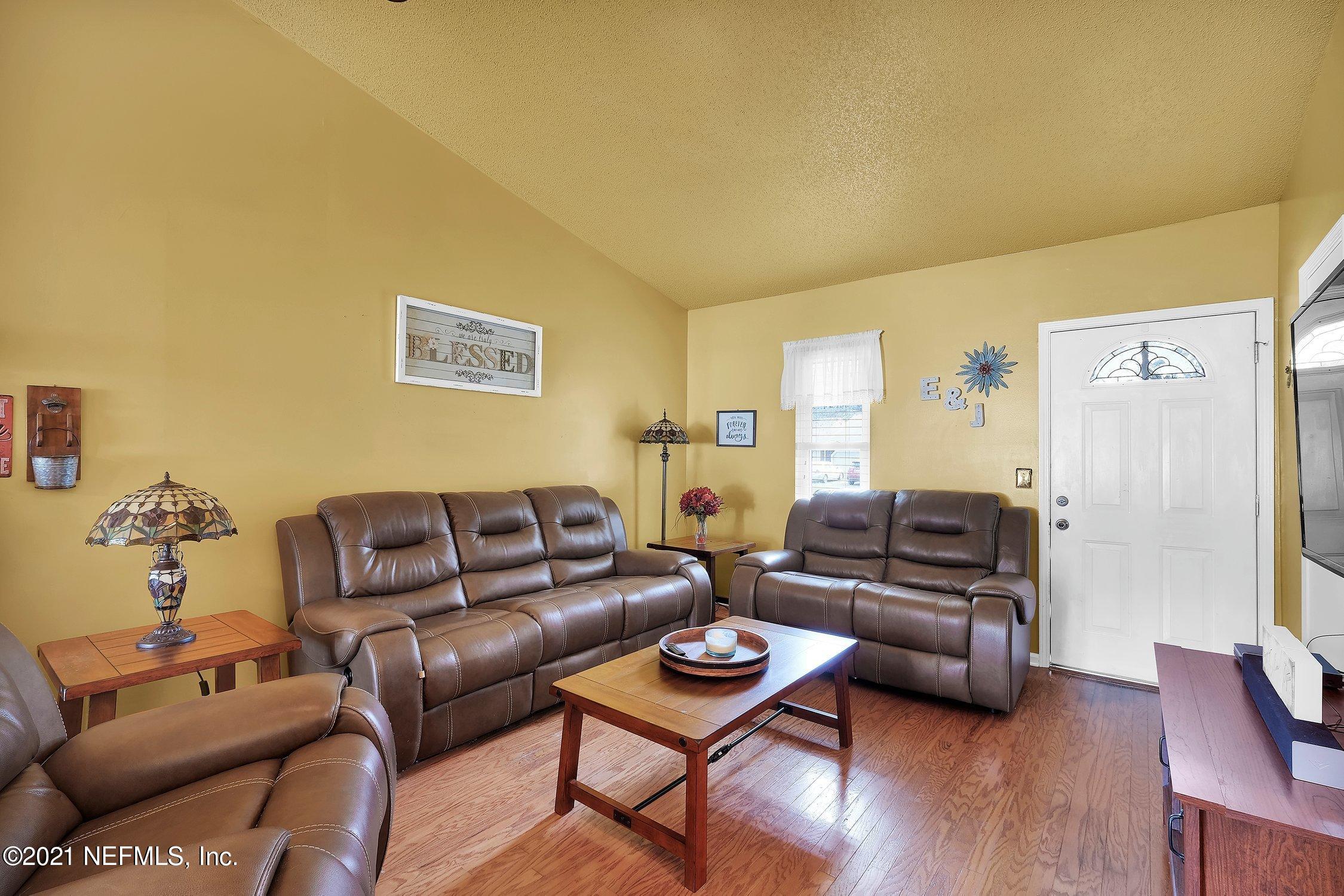 12840 Beaubien Road Jacksonville, FL 32258 - Photo 6 of 25 a living room with furniture and a wooden floor