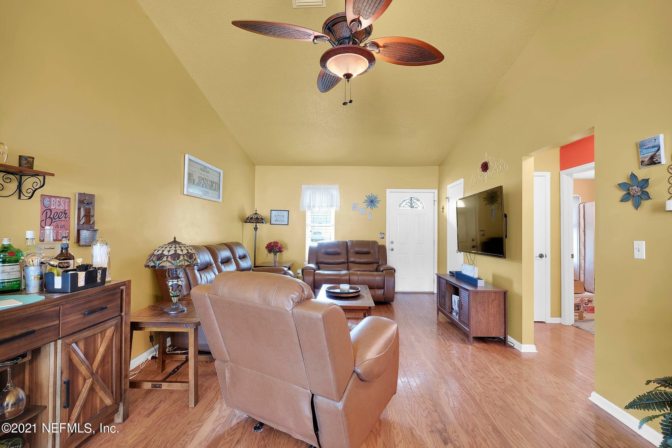 12840 Beaubien Road Jacksonville, FL 32258 - Photo 7 of 25 a view of a livingroom with furniture and a flat screen tv