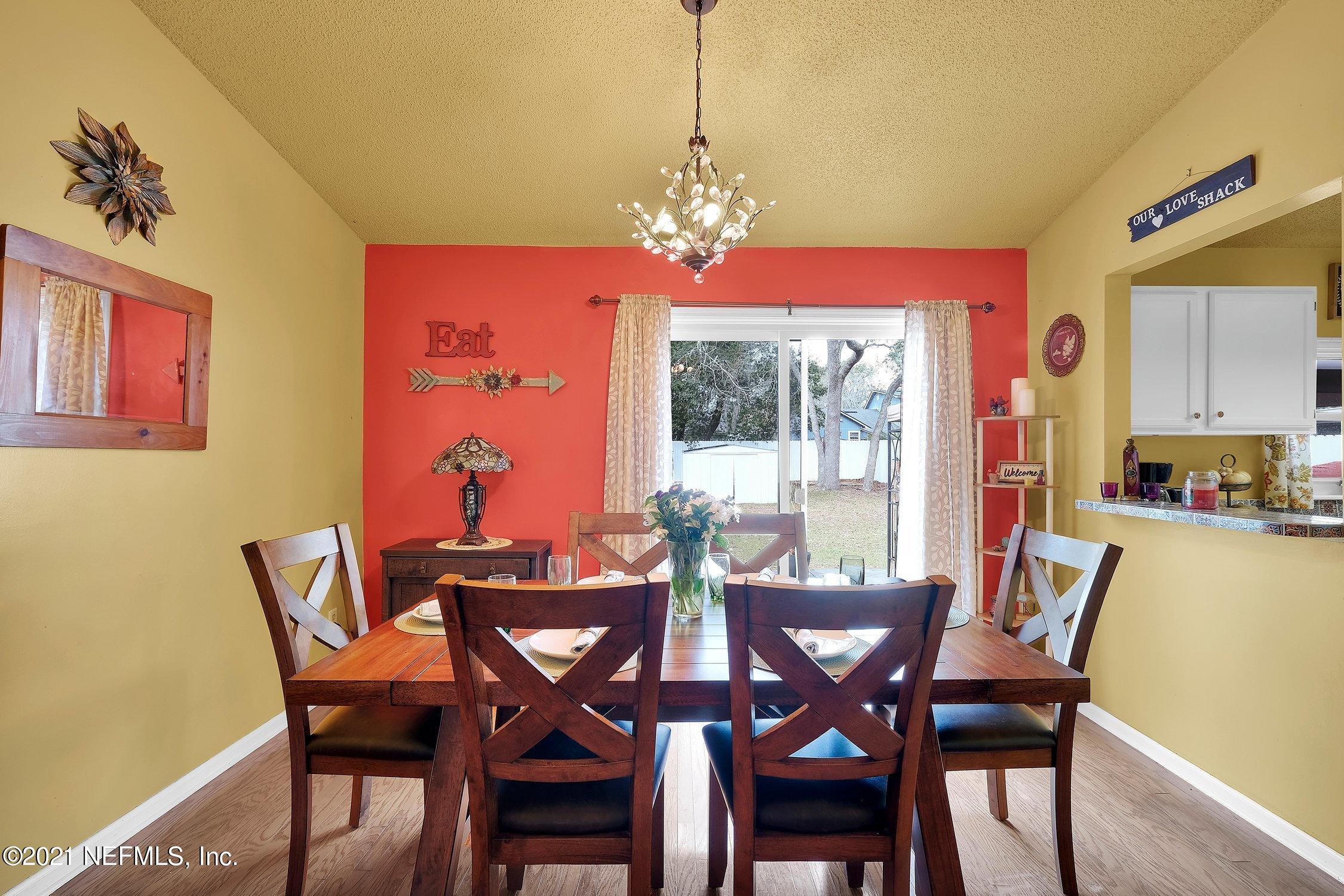 12840 Beaubien Road Jacksonville, FL 32258 - Photo 9 of 25 a view of a dining room with furniture and a chandelier