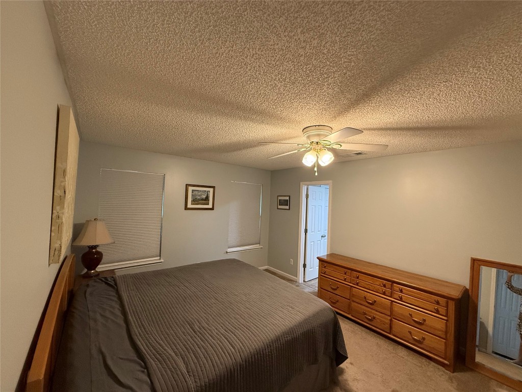 96118 Green Pine Road Yulee, FL 32097 - Photo 11 of 20 a bedroom with a bed and a ceiling fan