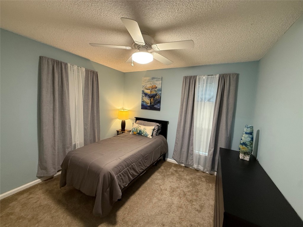 96118 Green Pine Road Yulee, FL 32097 - Photo 14 of 20 a bedroom with a bed and a chandelier