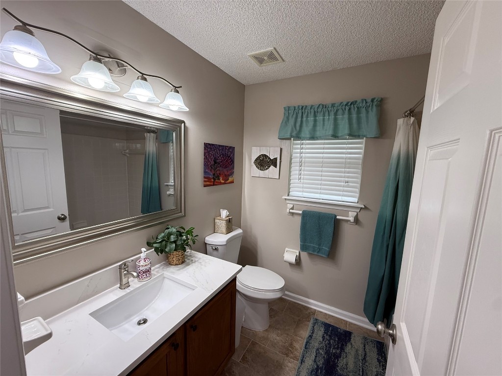 96118 Green Pine Road Yulee, FL 32097 - Photo 15 of 20 a bathroom with a sink a toilet a mirror and window