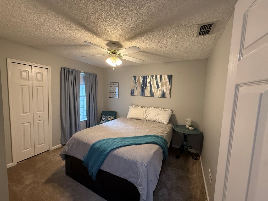 96118 Green Pine Road Yulee, FL 32097 - Photo 16 of 20 a bedroom with a bed and a chandelier