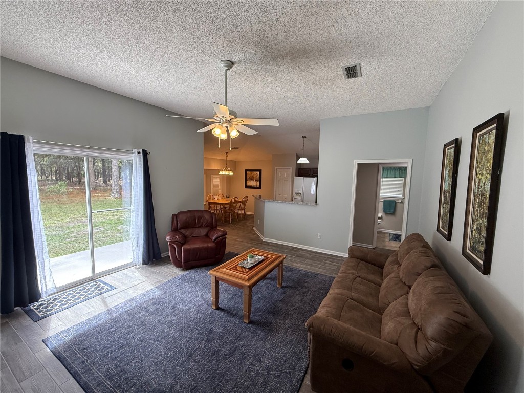 96118 Green Pine Road Yulee, FL 32097 - Photo 5 of 20 a living room with furniture and a chandelier