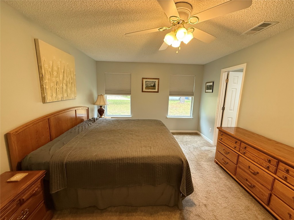96118 Green Pine Road Yulee, FL 32097 - Photo 10 of 20 a spacious bedroom with a bed and a chandelier