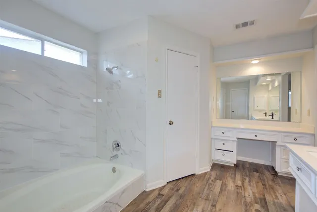 a spacious bathroom with a sink and a mirror