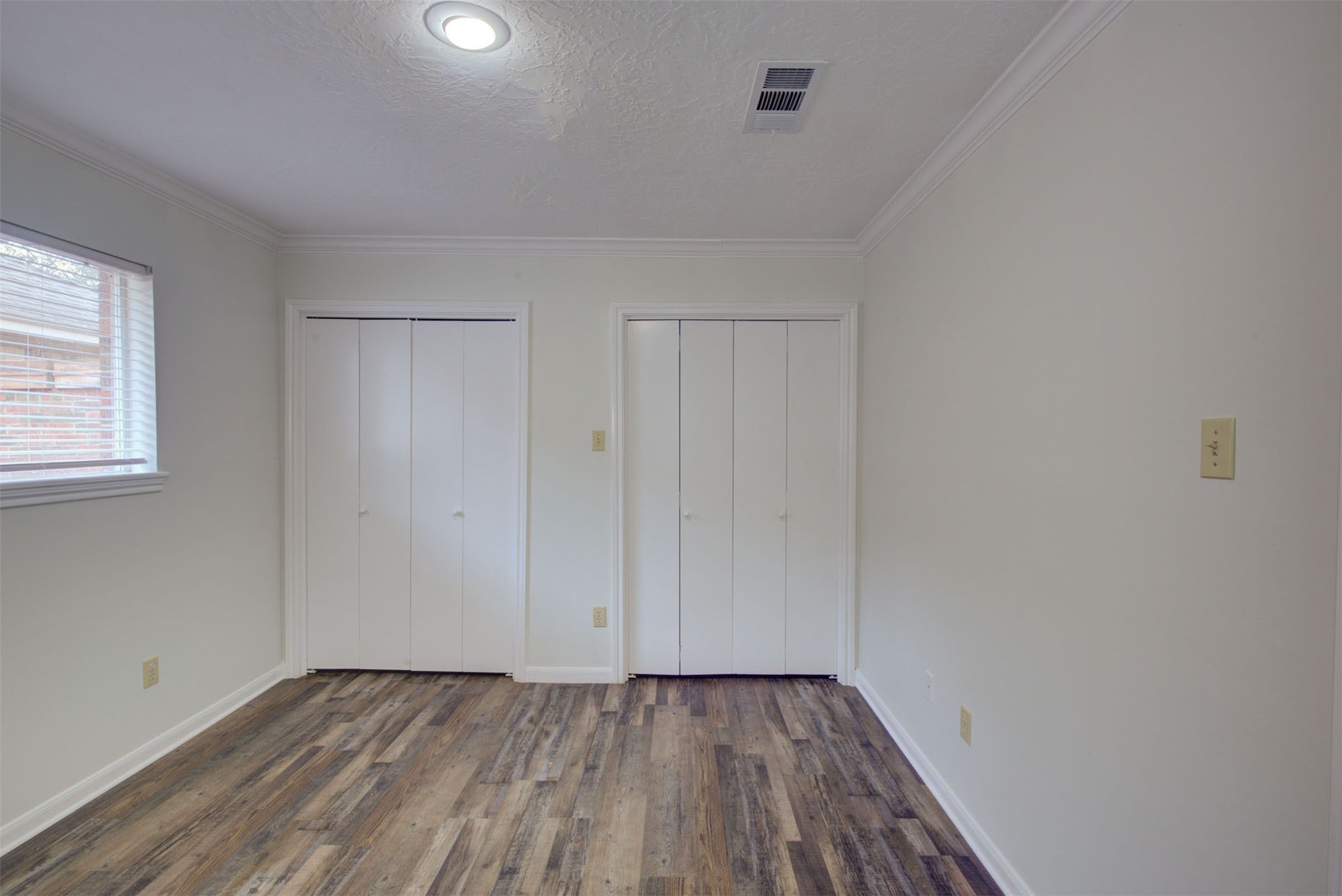 1402 Forest Home Drive Houston, TX 77077 - Photo 21 of 35 a view of an empty room with wooden floor and a window