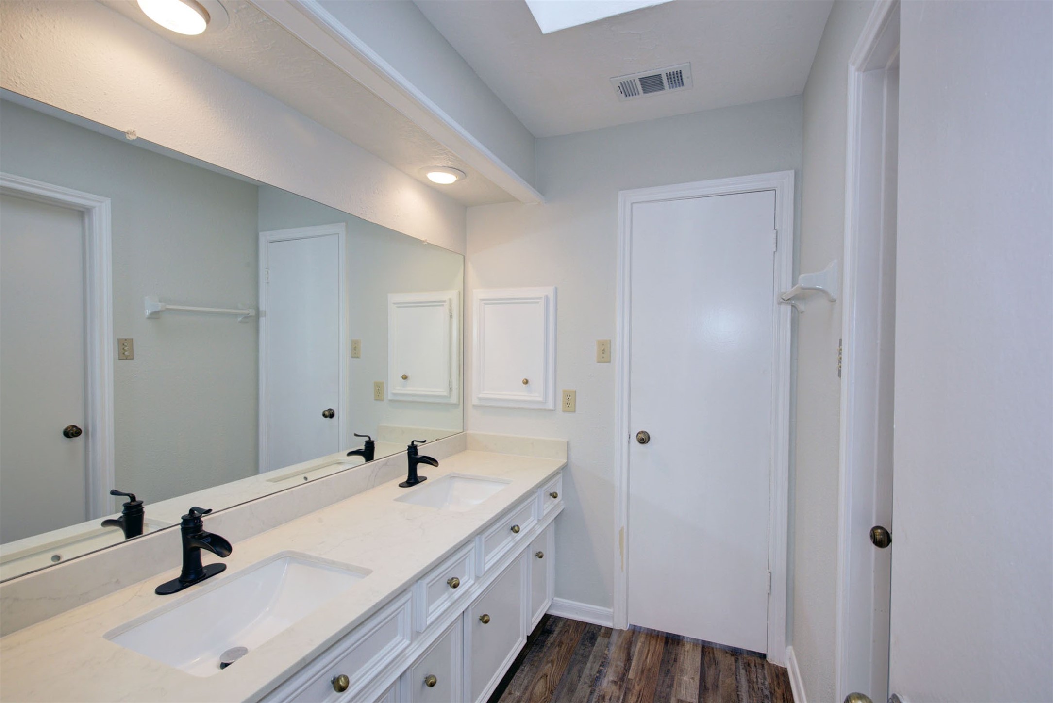 1402 Forest Home Drive Houston, TX 77077 - Photo 23 of 35 a bathroom with a sink and a mirror