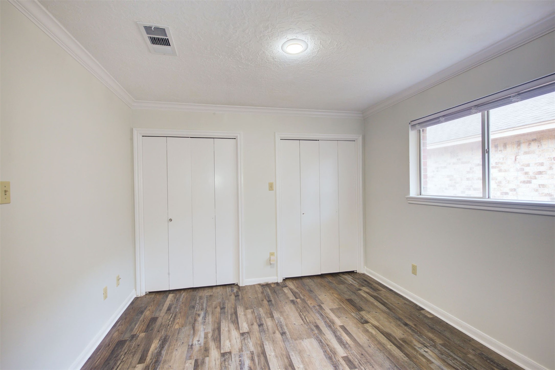 1402 Forest Home Drive Houston, TX 77077 - Photo 26 of 35 a view of an empty room with wooden floor and a window
