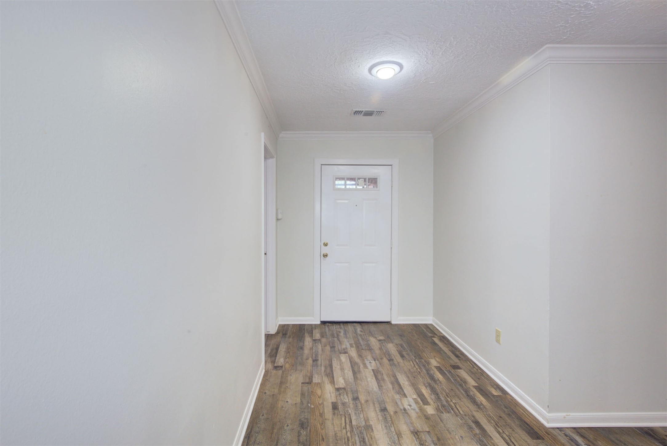 1402 Forest Home Drive Houston, TX 77077 - Photo 28 of 35 a view of a room with wooden floor and white walls
